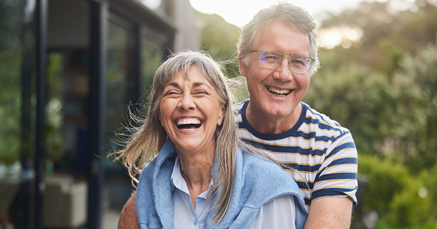 An older couple outside laughing